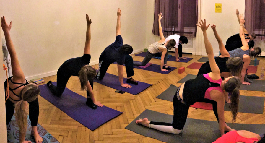 Indoor yoga session inside a calm and traditional asram space