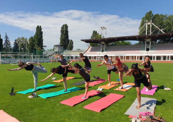 Corporate yoga class with employees practicing together